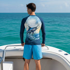 Man wearing a long-sleeve sun rashie with a marlin design on a fishing boat