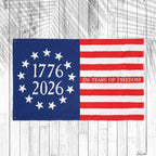 American flag with '1776 2026 250 Years of Freedom' text on a wooden background