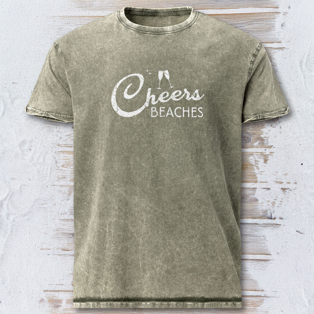 Green t-shirt with 'Cheers Beaches' text on a textured white background