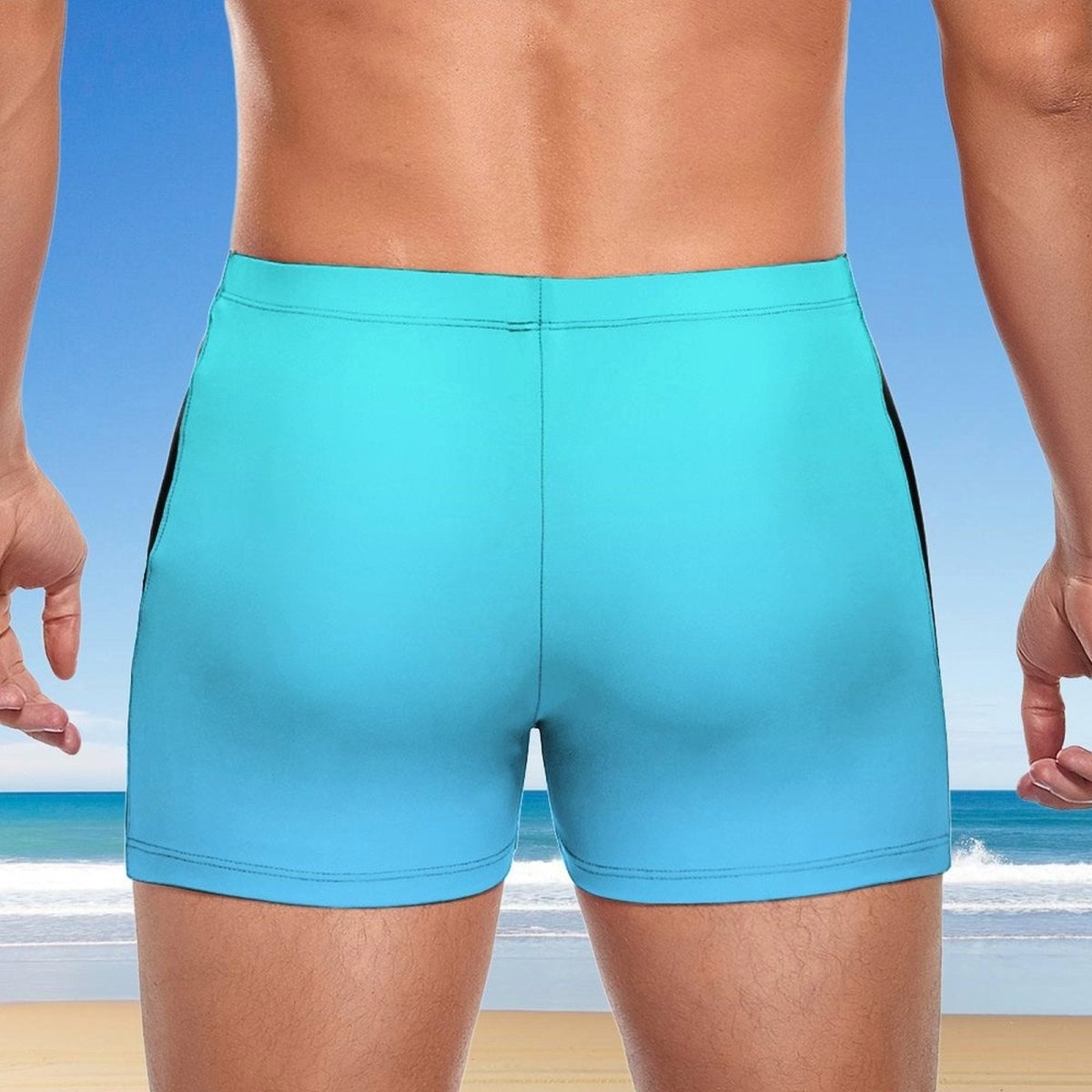 Person wearing turquoise swim shorts with a beach background