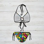 Bikini set with a colorful geometric pattern on the bottom and clear top on a white background