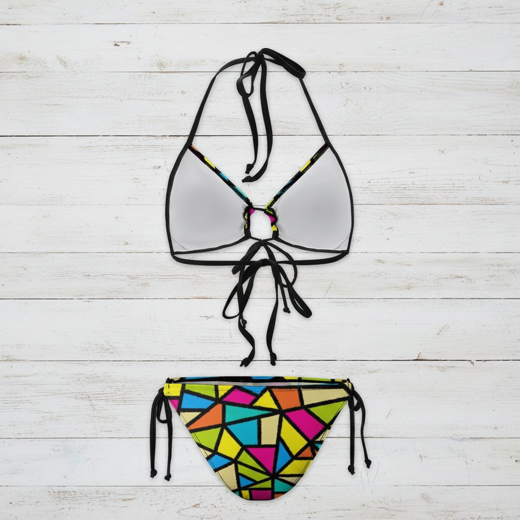 Bikini set with a colorful geometric pattern on the bottom and clear top on a white background