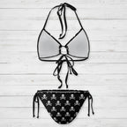Black and white bikini set with skull and crossbones pattern on a white background
