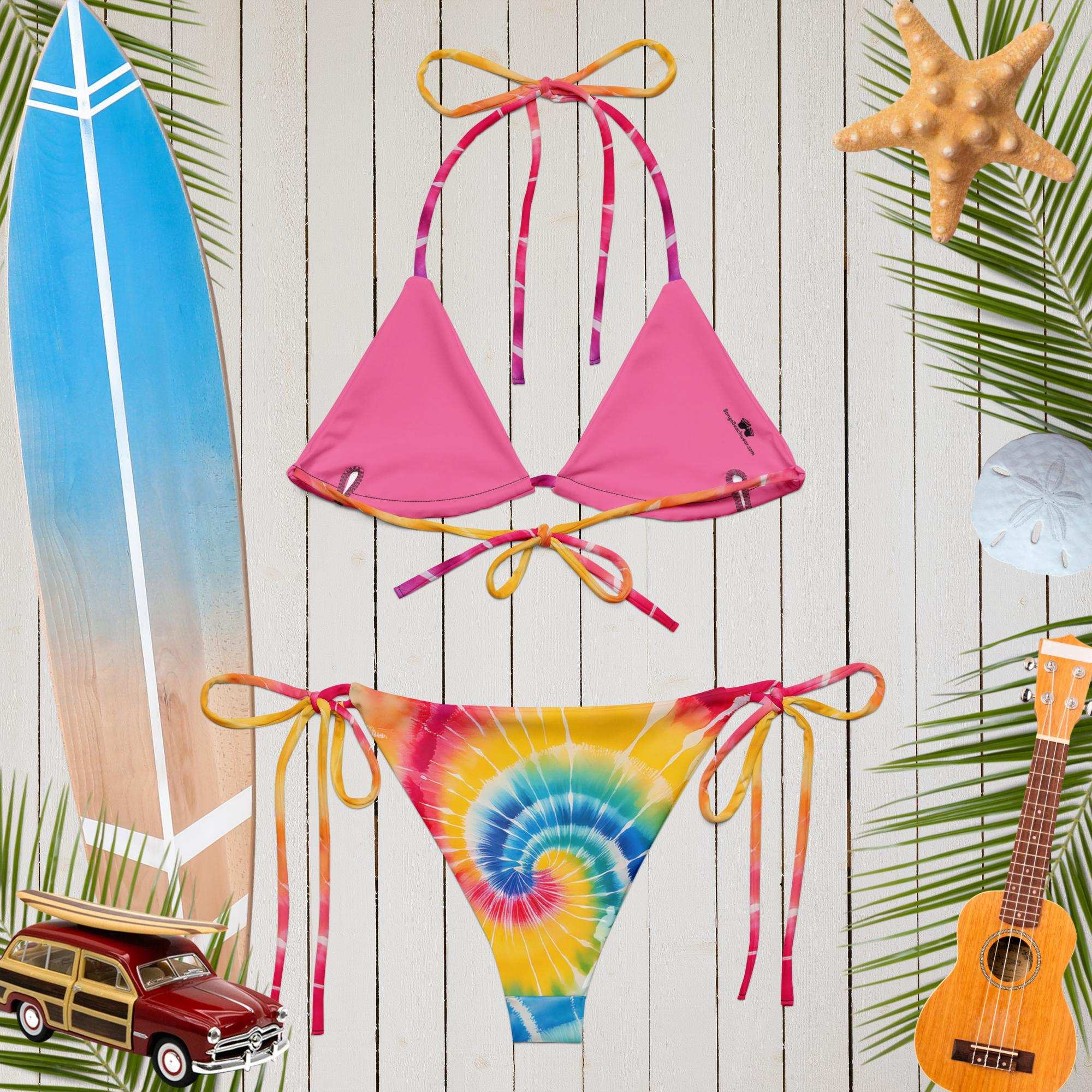 backside of the tie-dye string bikini over a rusic wood deck
