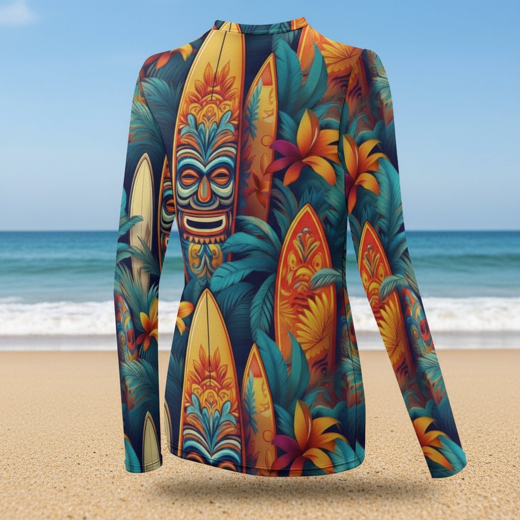 Colorful long-sleeve shirt with tropical design featuring masks and surfboards on a beach background.