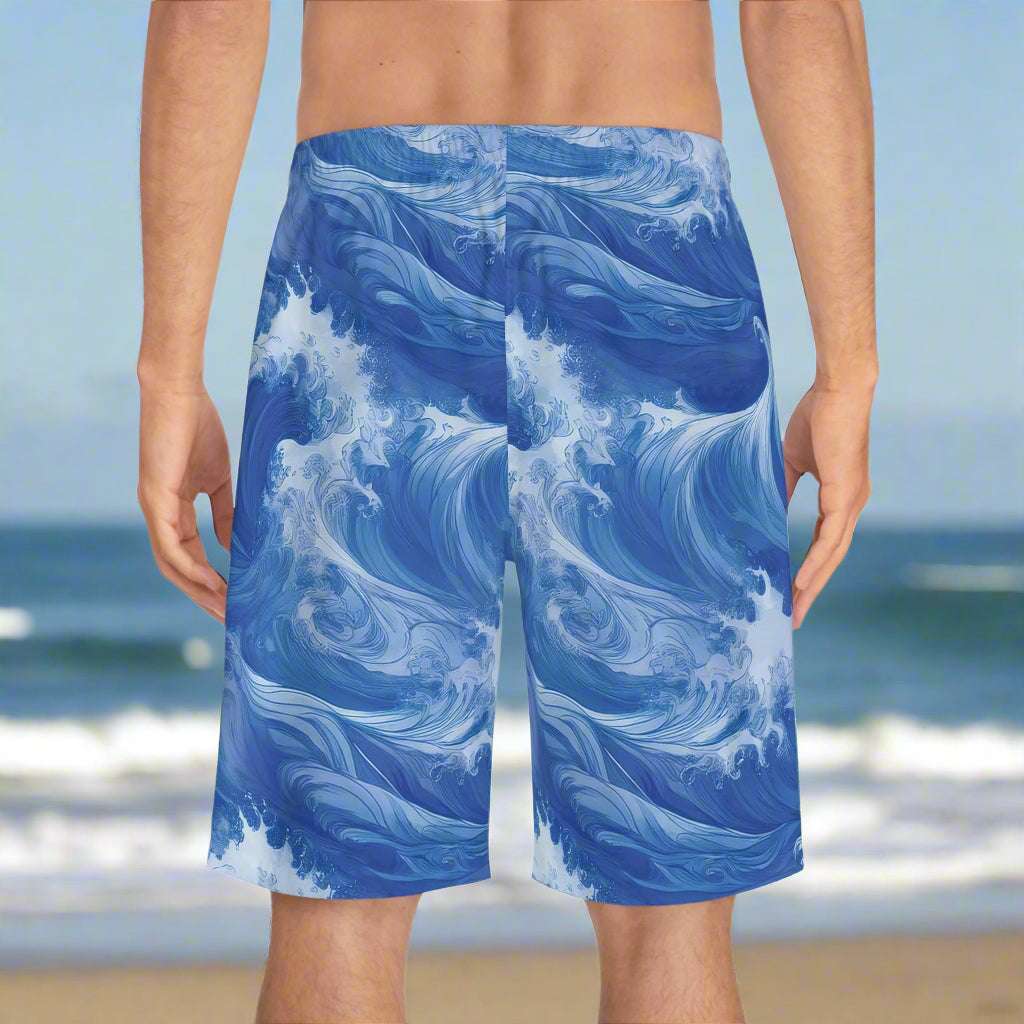 Surfer dude wearing rad board shorts looking out over the ocean