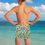 Dude wearing colorful tropical-themed swim shorts looking out over the ocean in Waikiki