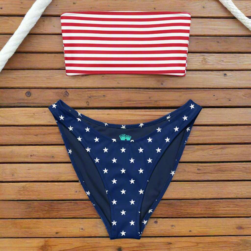 USA Flag themed Bandeau Bikini laid out flat on the deck of a sailboat in a marina in Miami