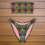 Bandeau bikini with crochet pattern print lying on a teak deck of a vintage sailboat