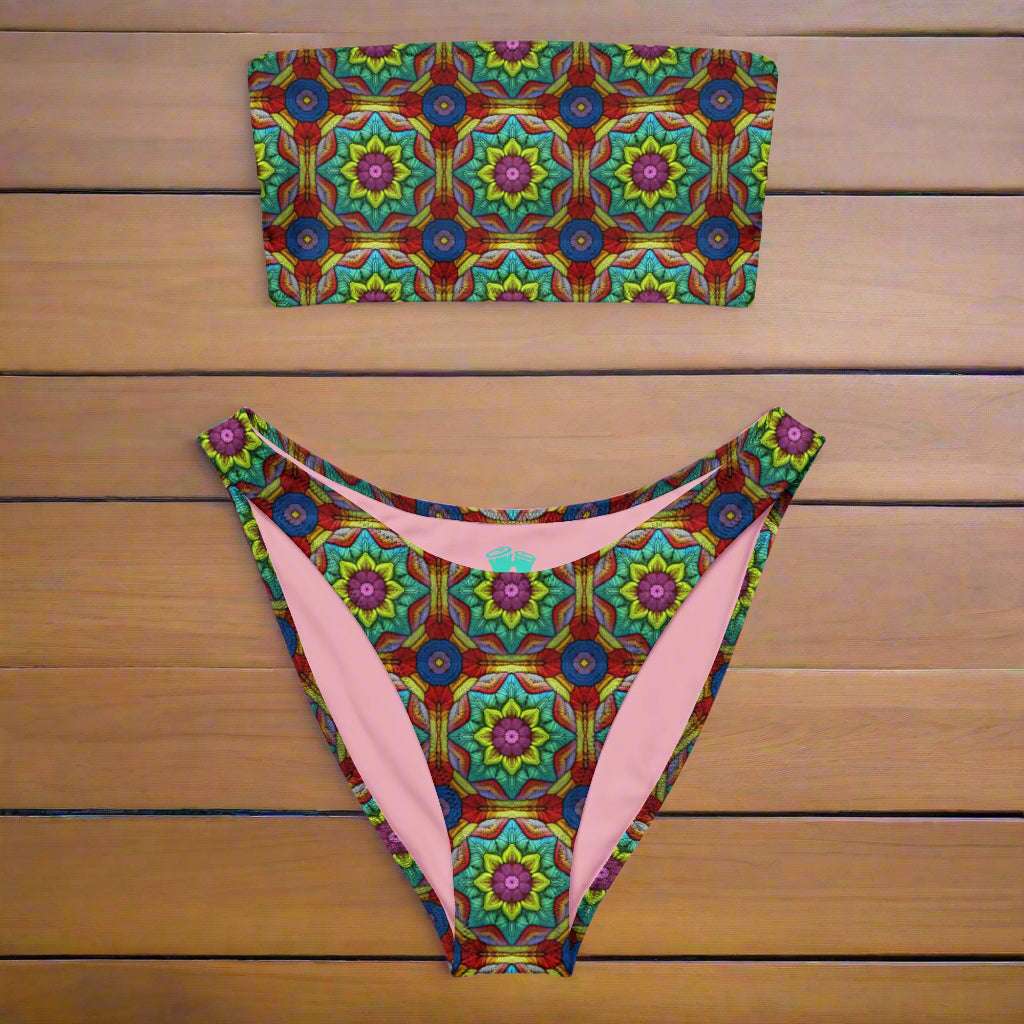 Bandeau bikini with crochet pattern print lying on a teak deck of a vintage sailboat