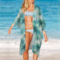 Swimsuit Model in a tropical patterned cover-up and bikini on a beach