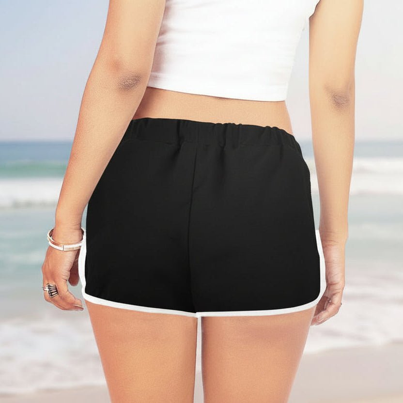 Person wearing black shorts with white trim on a white background