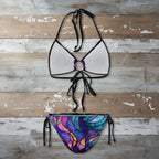 Bikini set with a colorful stained glass-style top and bottom on a rustic wood background