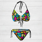 Colorful geometric-patterned bikini set on a white background