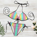Colorful striped bikini set with black straps on a white background