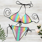 Colorful striped bikini set with black straps on a white background