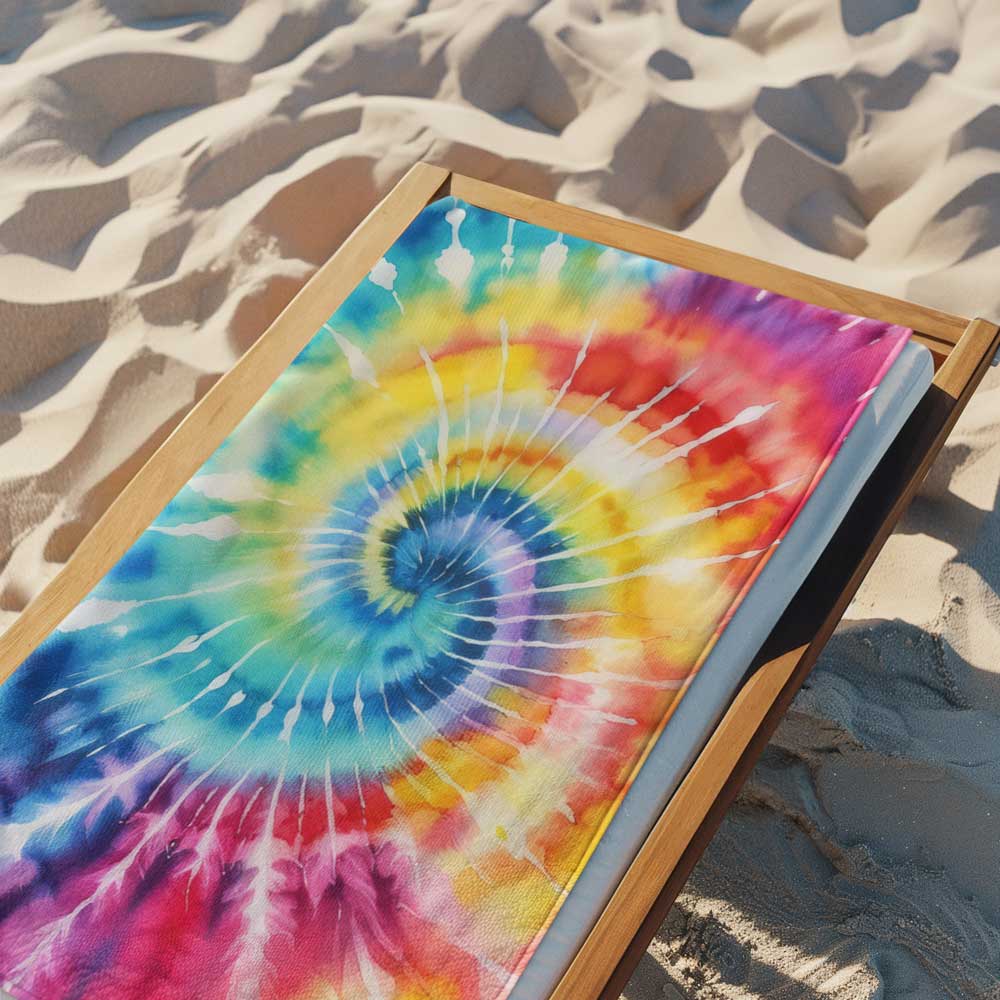 Beach towel lying on a lounge chair over the sand of a tropical island beach