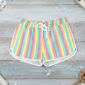 Pastel striped shorts worn by a person on a white background