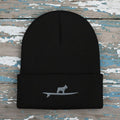 A black ribbed knit beanie hat with a folded cuff, featuring a small gray embroidered graphic of a frenchie bulldog standing on a surfboard on the front.