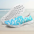 A pair of slip-on water shoes with a bright blue upper covered in a white dolphin pattern, shown with one shoe displaying the side pattern and the other showing the textured white sole.