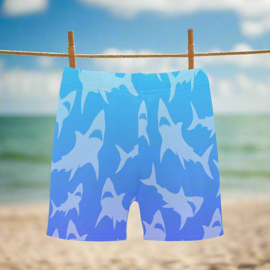 Blue shorts with shark pattern hanging on a clothesline at the beach in Key Largo