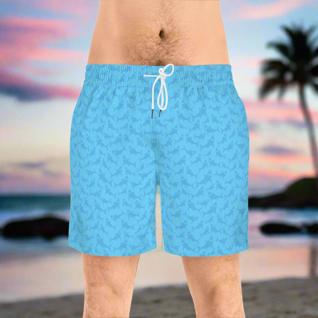 Blue Tone Shark Swimsuit worn by surfer dude standing on the beach