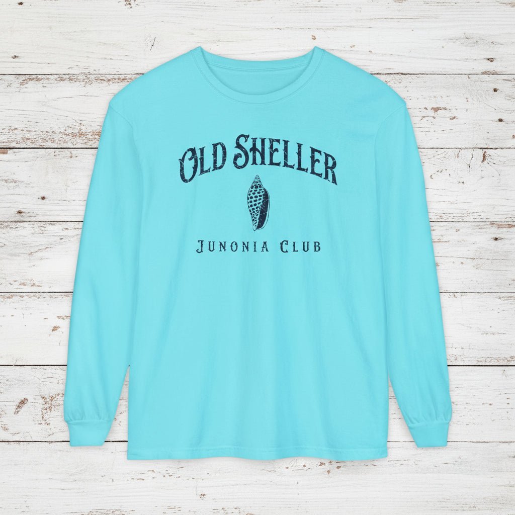 Light blue long-sleeve shirt with 'Old Sheller Junonia Club' text and shell graphic on a white background