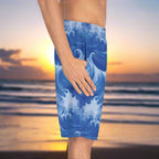 guy wearing board shorts with cool ocean wave pattern standing on the beach