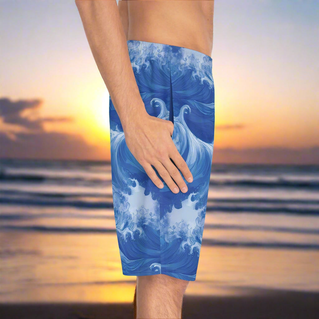 guy wearing board shorts with cool ocean wave pattern standing on the beach