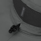 Close-up of Columbia logo on a gray booney hat with adjustable pulltab.