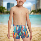 Boy wearing colorful surfboard-patterned swim shorts, hanging loose in Waikiki 