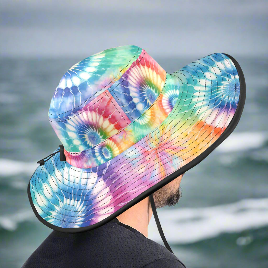 Colorful tie-dye bucket hat with a black brim on a guy sailing through the gulf stream.