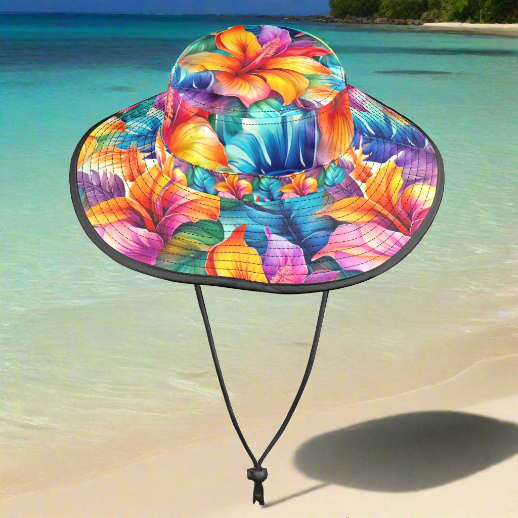 Colorful Hawaiian Style floral-patterned sun hat with a black chin strap on a beachy background