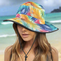 Colorful bucket hat with feather pattern worn by a model on Waikiki Beach
