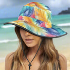 Colorful bucket hat with feather pattern worn by a model on Waikiki Beach