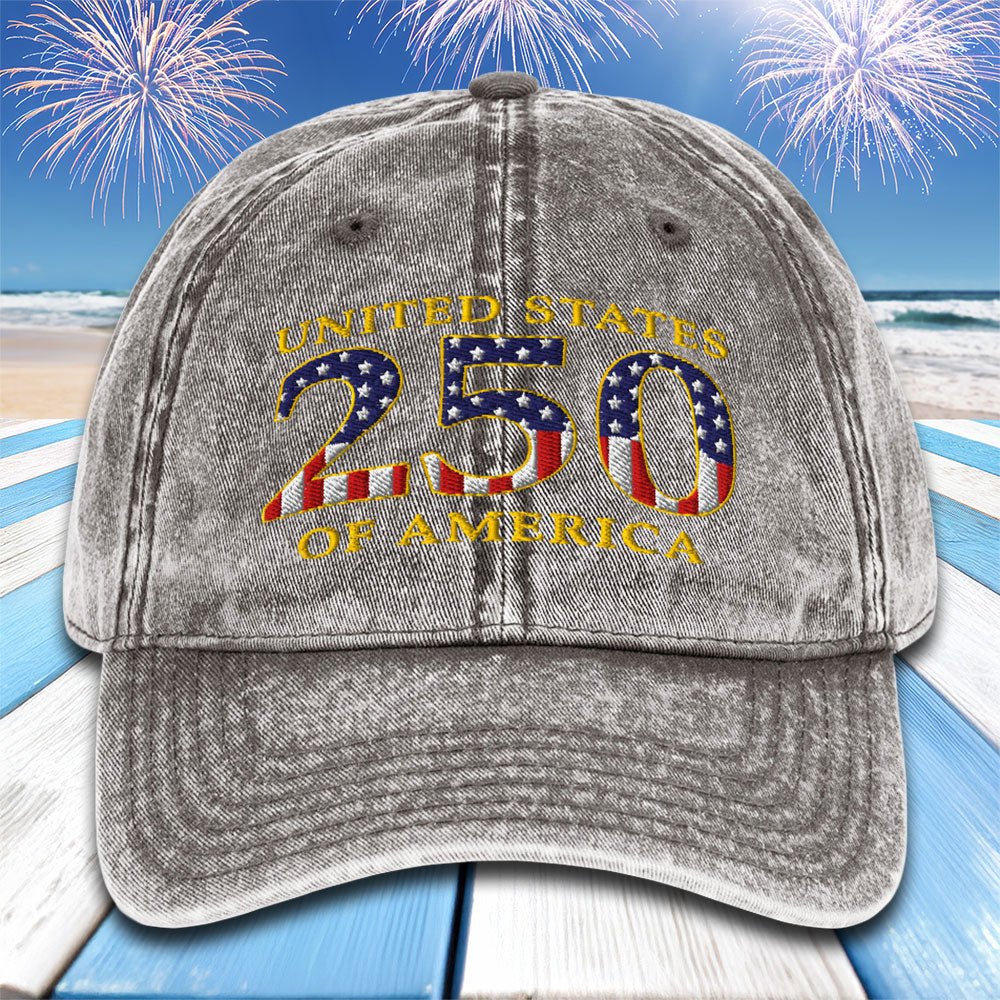 Gray cap with 'United States 250 of America' text and American flag design on a beach with fireworks background