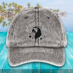 Gray cap with 'Bubbles Up!' text and black logo on a teal surface with a scenic background