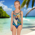 Girl in One Piece bathing suit adorned with Surfer in the Sun artwork by Bongo Beachwear standing in sand where ocean meets land looking out over the waves.