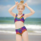Young girl wearing a colorful swimsuit on Cocoa Beach