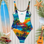 Vibrant Hawaiian print one-piece women's swimsuit with a scoop neckline and beach accessories in the background.