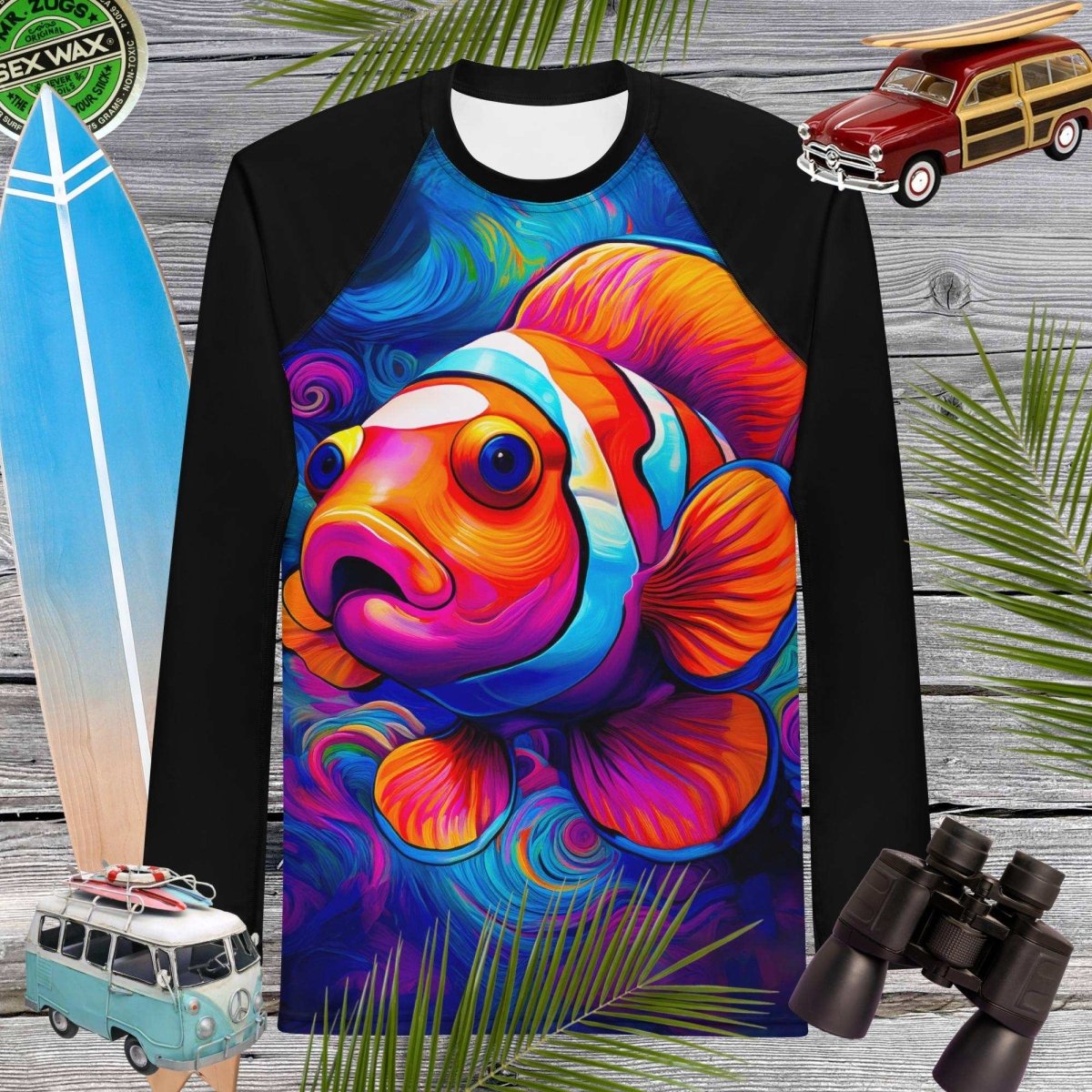 Long-sleeve rash guard with a colorful clown fish design on a wooden background with surfboard, car, and binoculars.