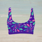 Purple bikini top with colorful seashell pattern on a nautical wood background