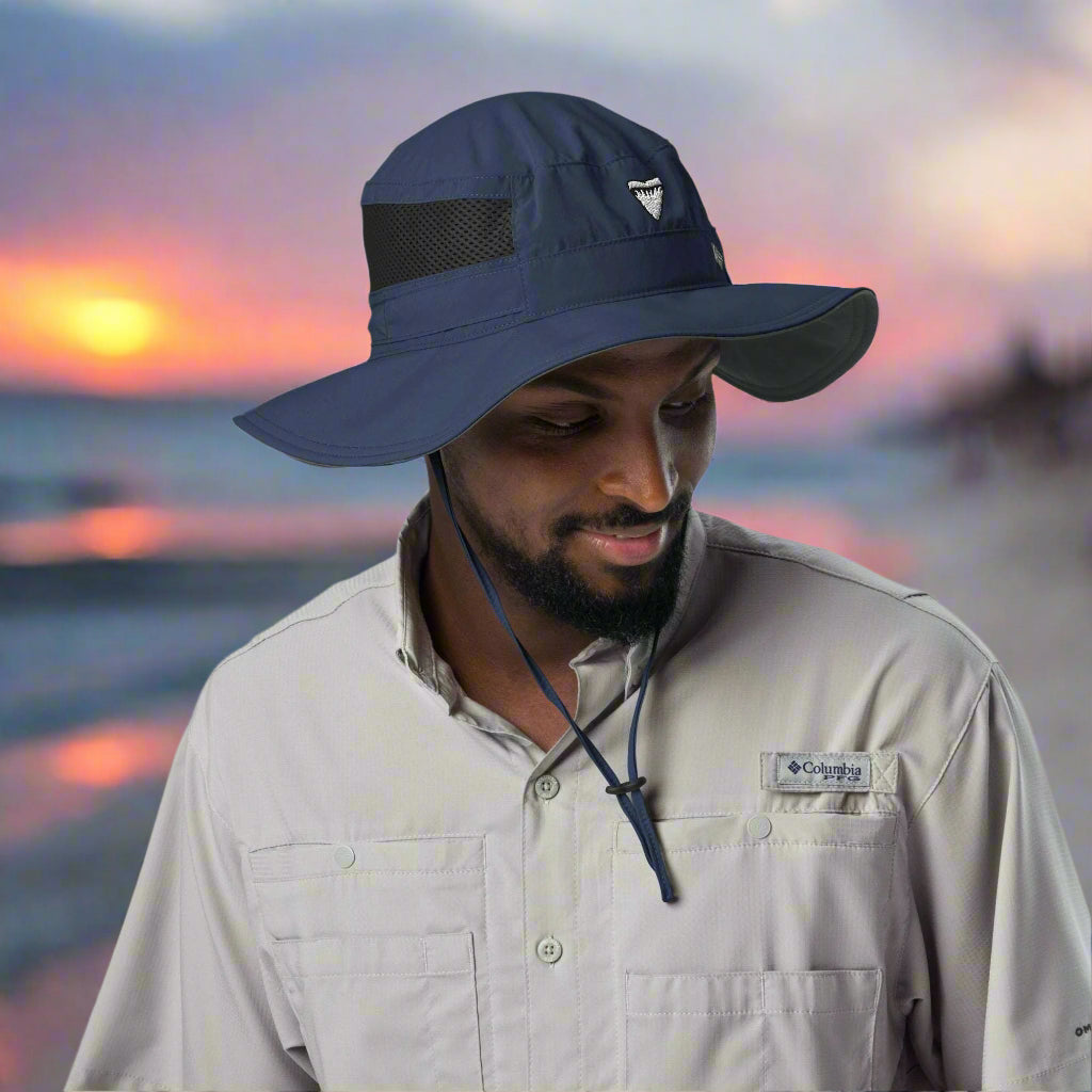 Dude wearing a Shark Tooth "Booney" Hat by Columbia Headwear on the baech