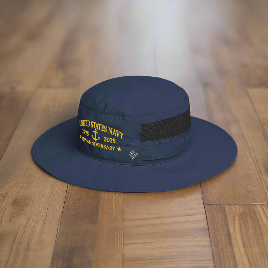Navy blue hat with 'United States Navy 247th Anniversary' text on a wood floor