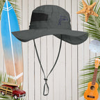 Gray sun hat with a dolphin logo on a wooden background with beach-themed decorations.
