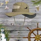 Sage Booney Hat by Columbia with a Rad Shark Embroidery  on front against a rustic wood background with shark teeth and nautical icons