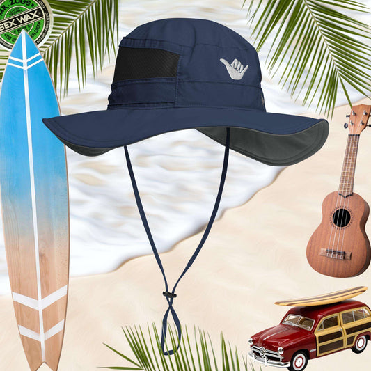 Navy blue sun hat with shaka sign embroidery surrounded by a surfboard, ukulele, and vintage car on a beach background