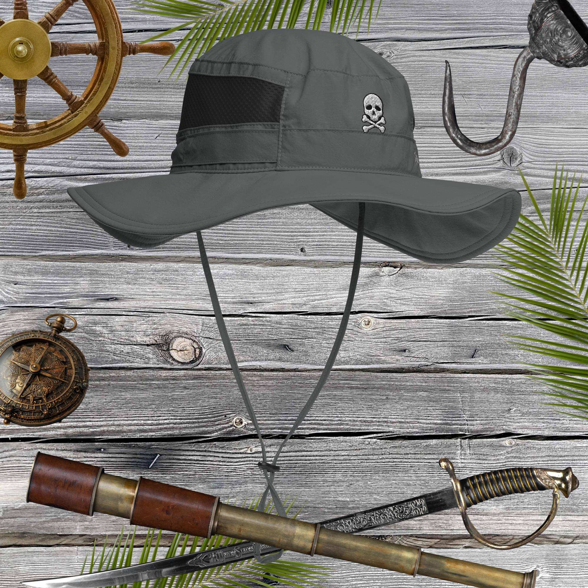 Gray sun hat with skull embroidery on a wooden background with nautical items.