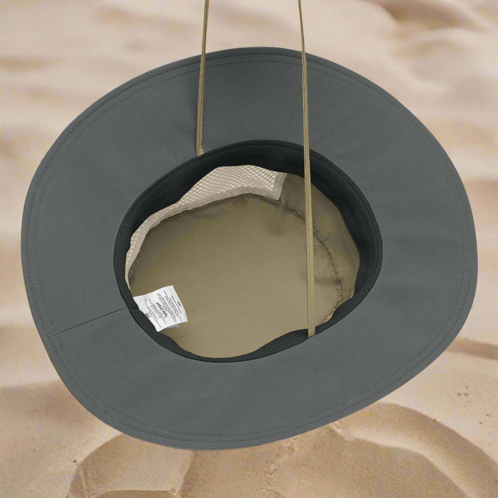 Sand Dollar Booney Hat by Columbia sitting upside down in the sand