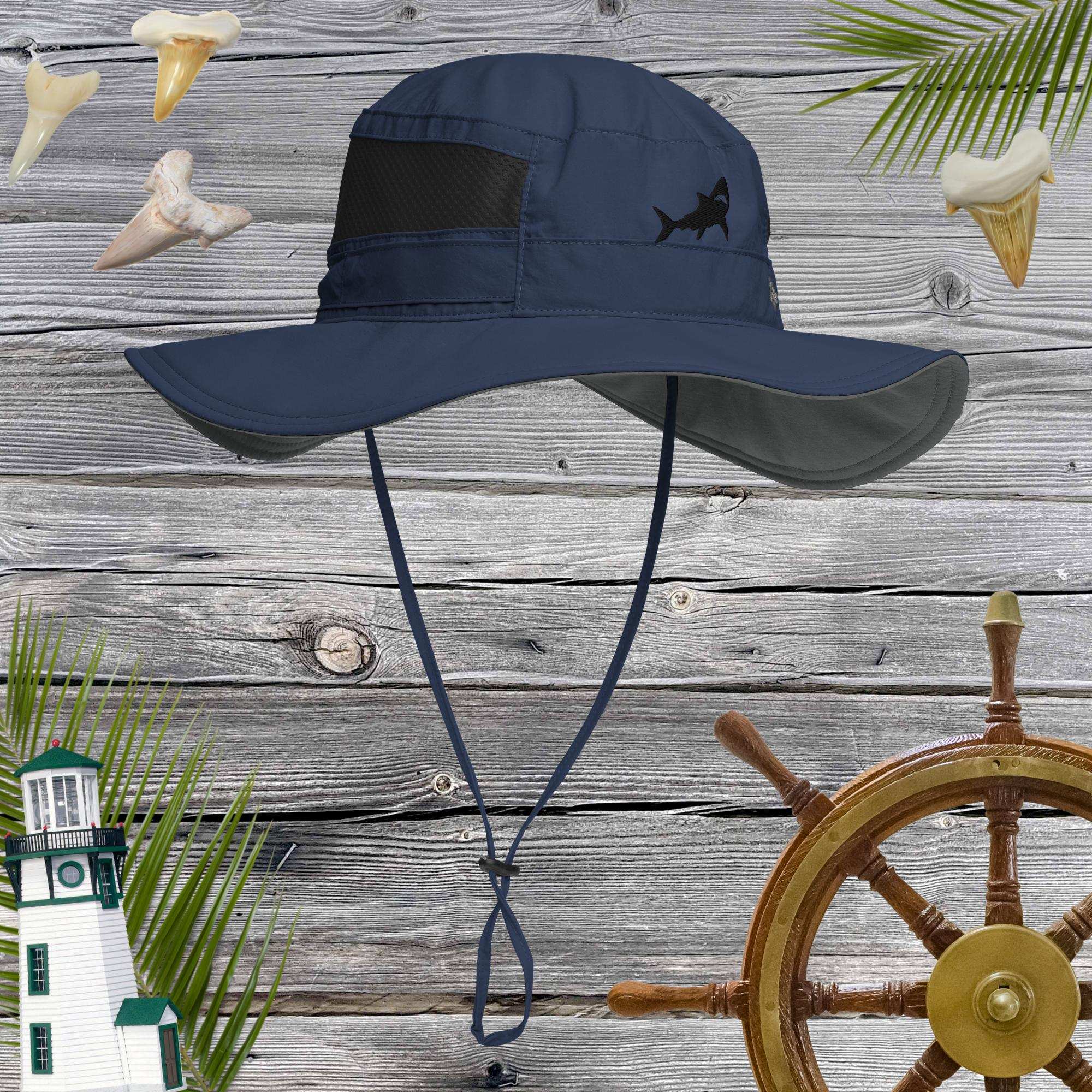 Navy blue bucket hat with shark design on a wooden background with nautical elements.